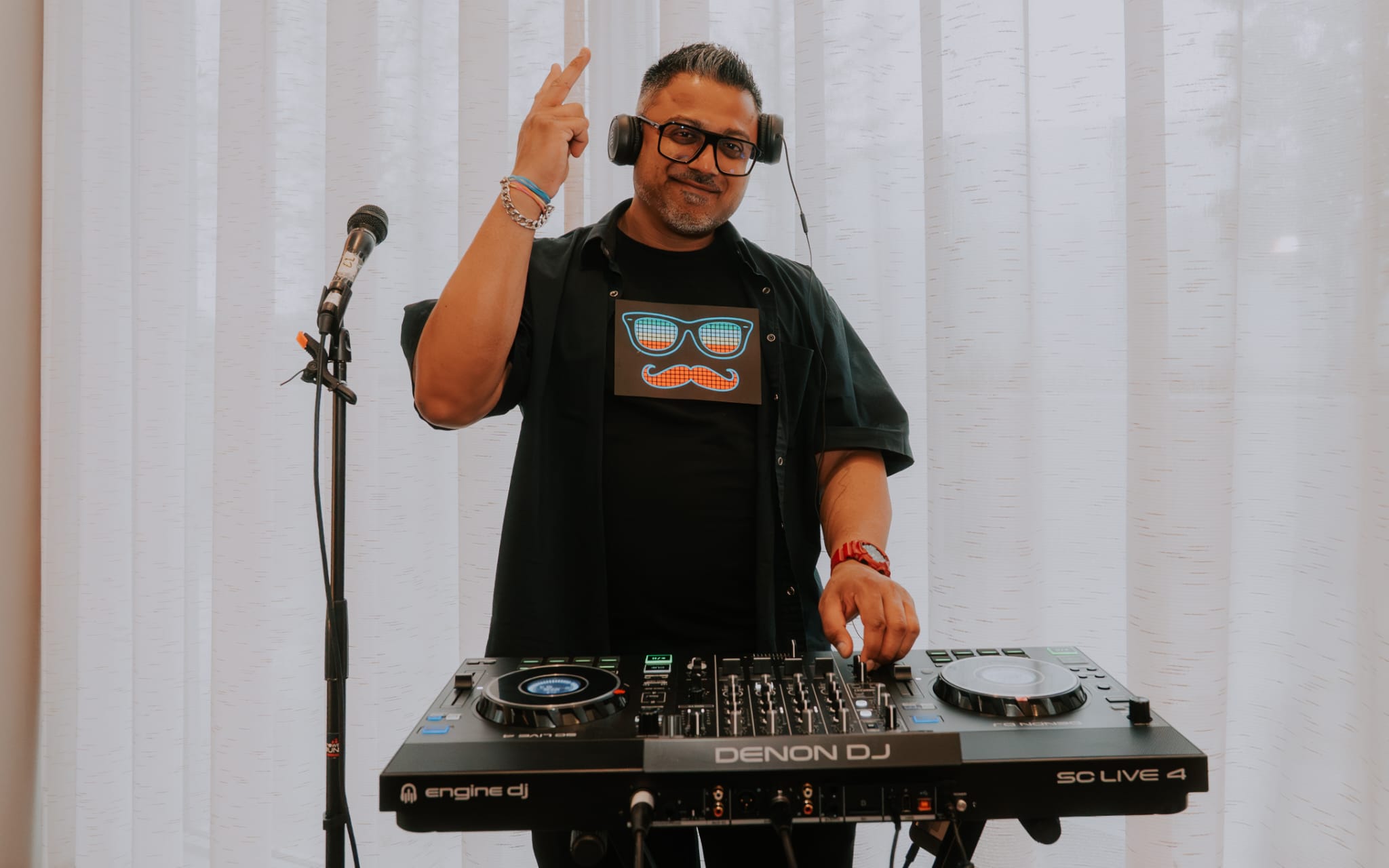 DJ performing with a Denon controller setup
