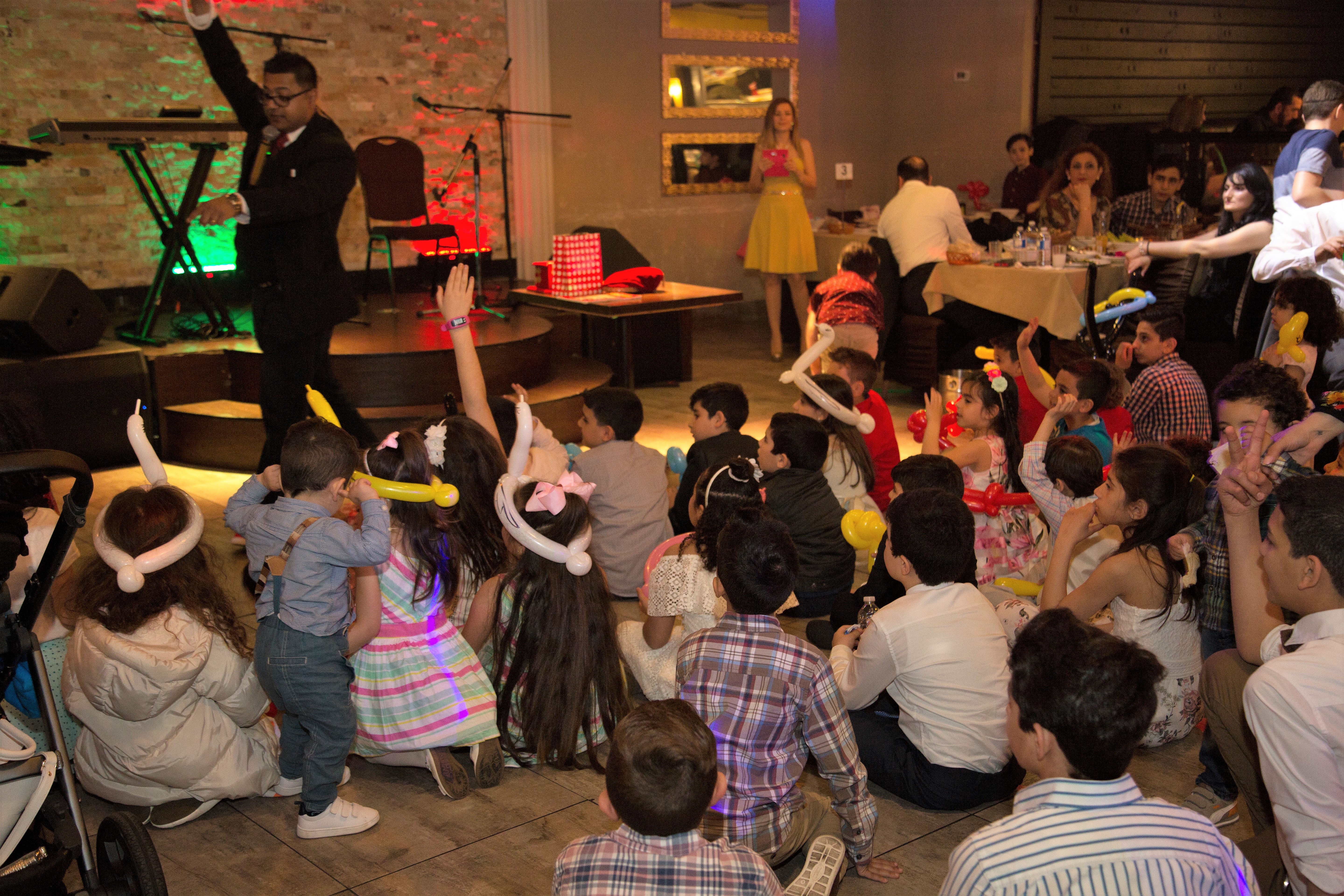 Full room watching a live performance