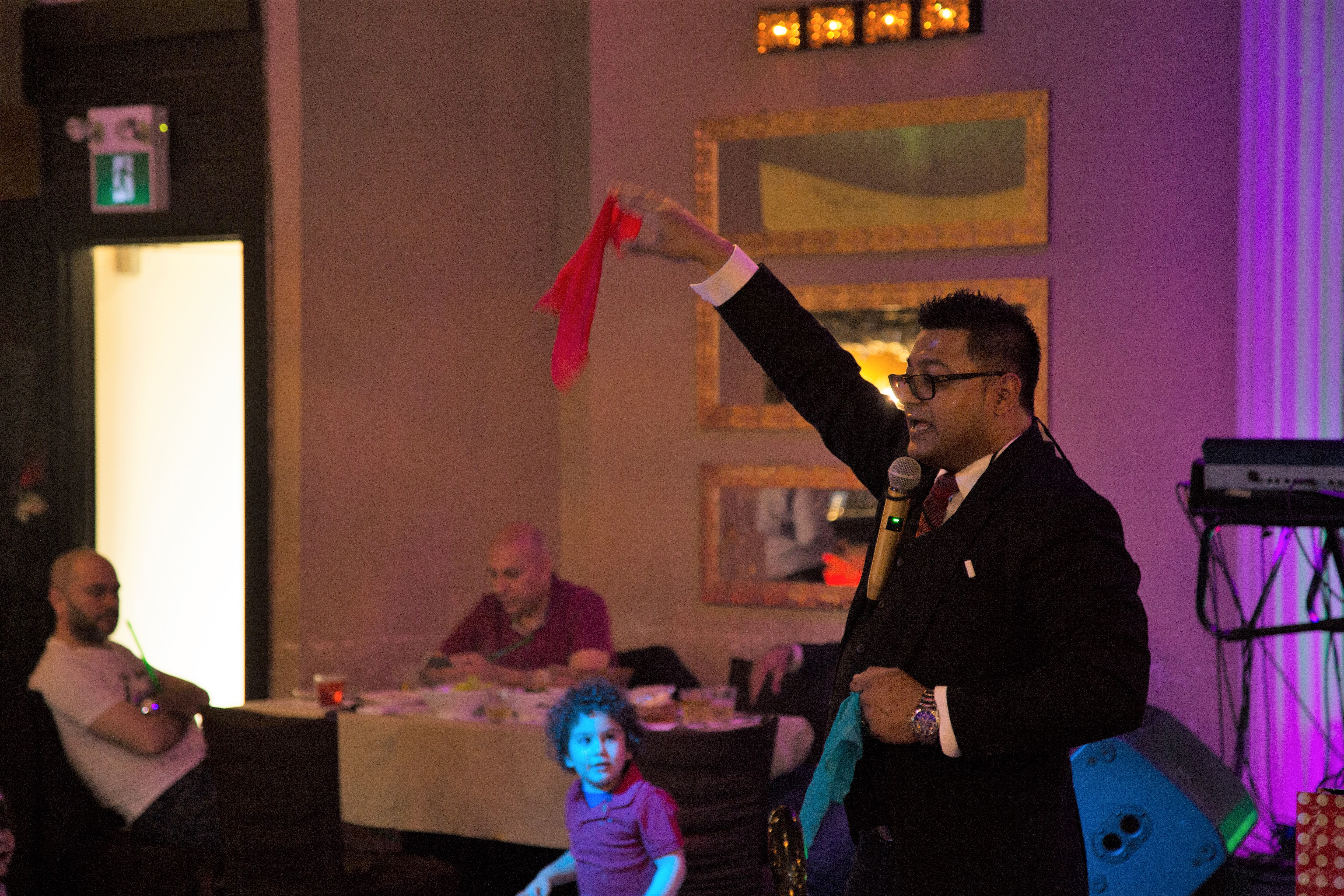 Stage magic performance under dramatic lighting